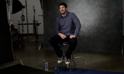 Jason Biggs sitting on a stool in a studio