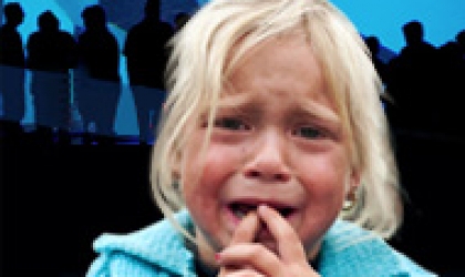 A girl is crying in front of an orca
