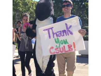 A group of people holding signs that say thank you Csulb