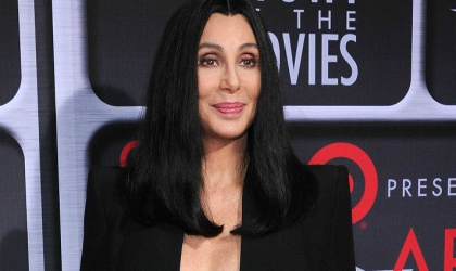 Cher posing on a red carpet.