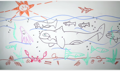 A child's drawing of a whale in the ocean.