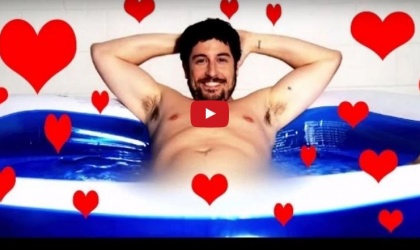 Jason Biggs lounging in a tub adorned with hearts.