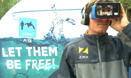 A man wearing headphones looks into a vr headset