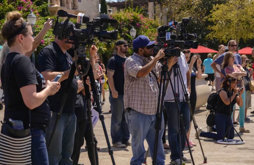 A group of people standing in front of a camera.