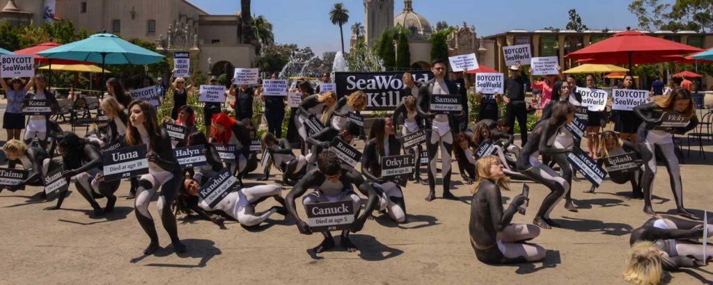 A group of people holding signs in front of a building.