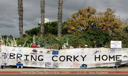 Activists hold a large banner reading "Bring Corky Home" at Corky 47-year anniversary demo