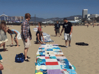 People on beach looking at 15-mile-long "Free Corky" banner