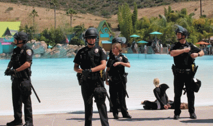 A group of police officers standing near a pool.