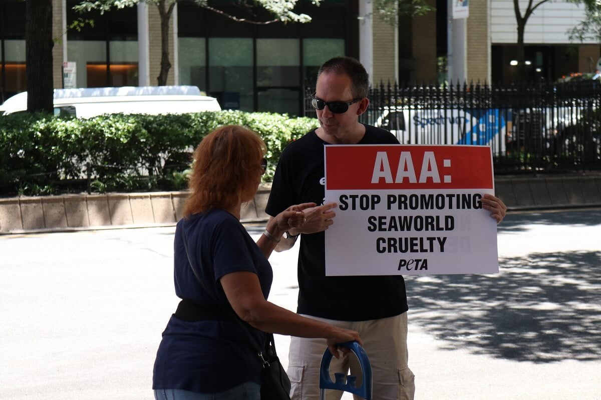 A woman holding a AAA sign.